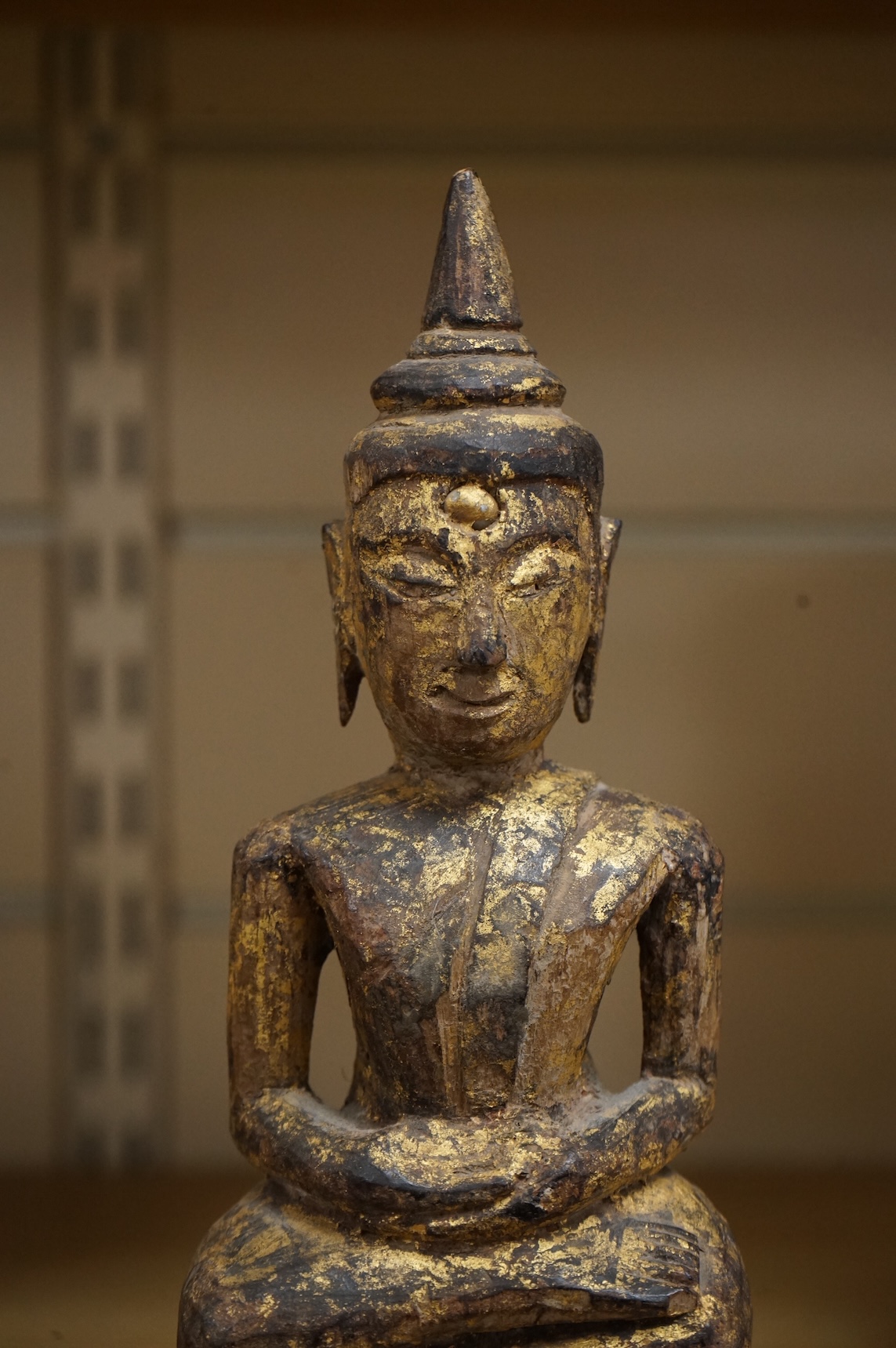 A Burmese giltwood figure of seated Buddha, 24cm high